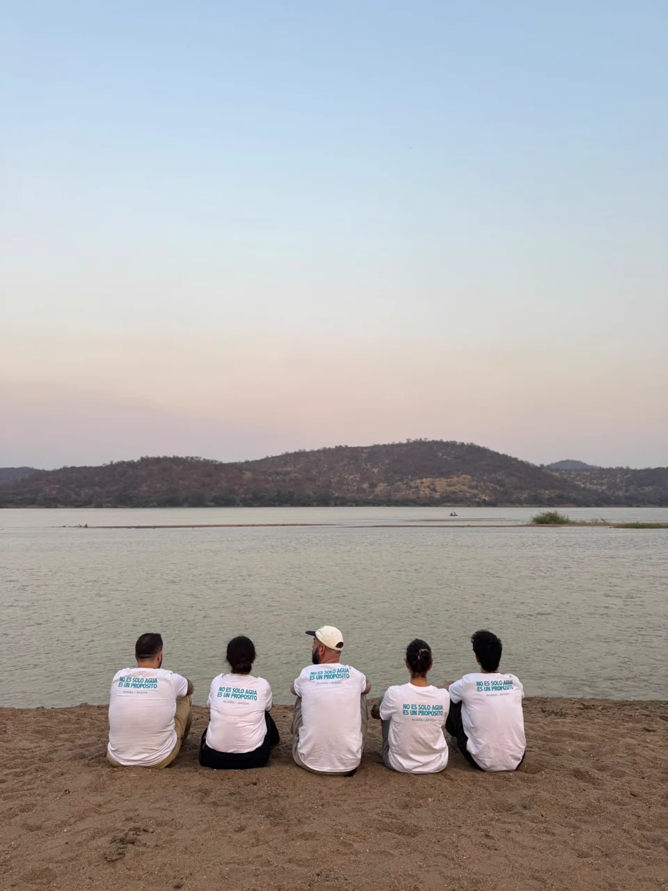 Equipo del proyecto de agua sentado frente a un paisaje de Mozambique